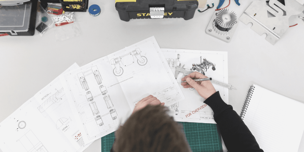 Header image showing man doing technical engineering drawing